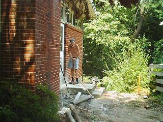 Dad resting after breaking the stoop with a pick axe